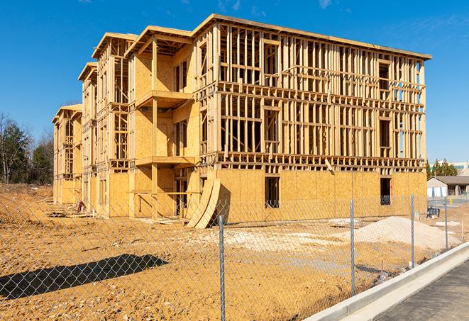 a temporary chain link fence in front of a building under construction, ensuring public safety in Malibu